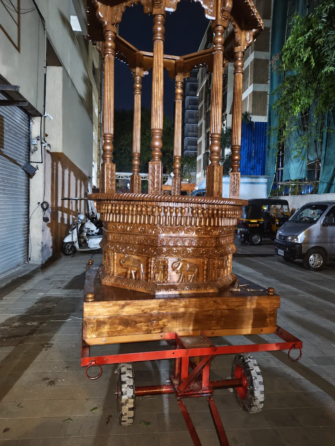 AI-retouched project photograph of a wooden temple chariot with people removed